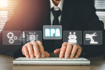 RPA Robotic Process Automation Innovation technology concept, Person typing keyboard computer with VR screen RPA icon on office desk.
