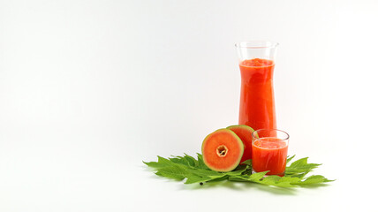 Papaya smoothie in glass jar and glasses on white background diet vegetarian healthy and freshness drink concept soft and selective focus