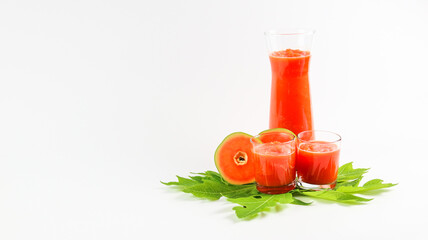 Papaya smoothie in glass jar and glasses on white background diet vegetarian healthy and freshness drink concept soft and selective focus