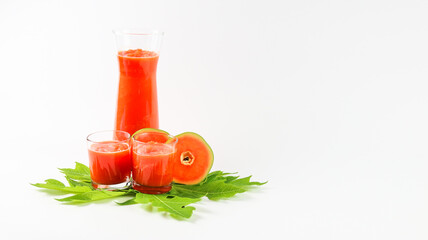 Papaya smoothie in glass jar and glasses on white background diet vegetarian healthy and freshness drink concept soft and selective focus