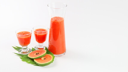 Papaya smoothie in glass jar and glasses on white background diet vegetarian healthy and freshness drink concept soft and selective focus
