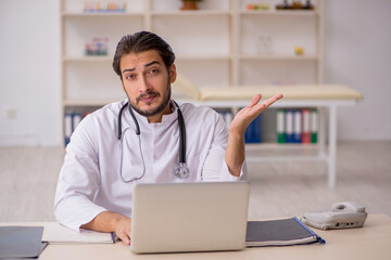 Young male doctor working in the clinic