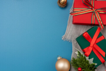 Christmas composition. festive decor on blue background. Copy space, flat lay, top view.