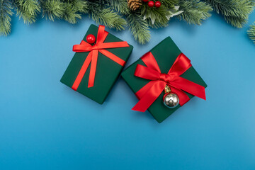 Flat lay composition with gift boxes and Christmas decorations on blue background, space for text. Christmas concept.