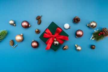 Christmas composition. festive decor on blue background. Copy space, flat lay, top view.