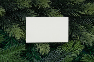 Christmas tree branches and blank Paper. Christmas concept, nature, winter. Background for postcards. Flat lay, top view