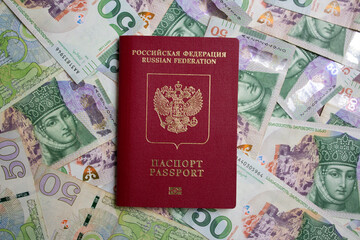 top view. Red Russian biometric passport on a background of green paper cash Georgian bills. Money for travel, tourism, immigration from Russia. 50 GEL. Currency exchange. flat lay. Buying citizenship