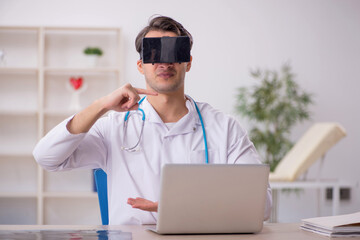 Young male doctor enjoying virtual glasses at the hospital