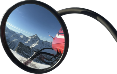 Snowy Mountains reflection  in the mirror from a helicopter