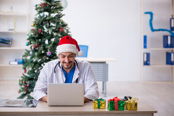 Young male doctor celebrating Christmas at the hospital