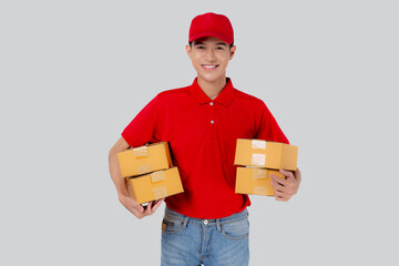 Young asian man in uniform red and cap standing carrying box stack isolated white background, employee holding cargo or package, courier and delivery, transportation and service, logistic and cargo.