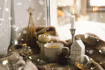 Christmas composition. Hot tea, candles, Christmas golden balls and decorations. Christmas holiday mood. Winter concept.