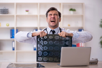Young male doctor radiologist working in the clinic