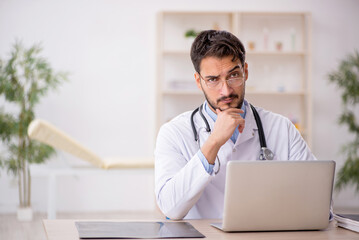 Young male doctor in telemedicine concept