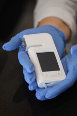 Hands holding special dermatology equipment system, hair loss and trichology concept. Analyzing Hair With Analysis System Digital Trichoscope. Close-up