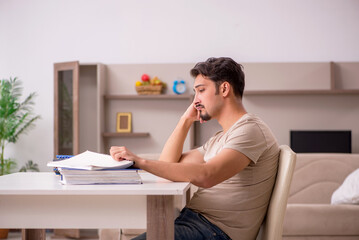 Young male employee working from house