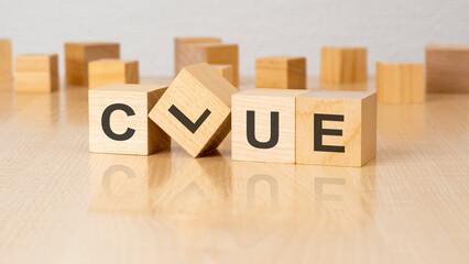 four wooden blocks with text CLUE on table. copy space. white background.