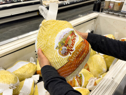 Sacramento, CA, USA November 11, 2022 Customer Holding A Frozen Norbest  Brand Organic Ranch Raised Whole Turkey For Sale In A Freezer At A Local Supermarket	