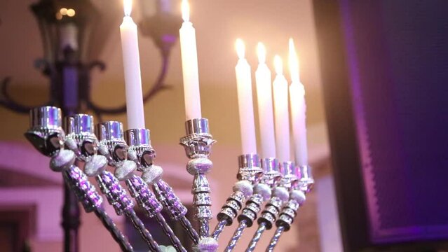 Hanukkah menorah with six candles in candelabra. Jewish holiday symbol celebration. Moving camera