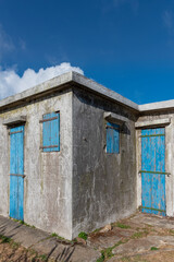 Fototapeta na wymiar Blue locked door and window of grunge building