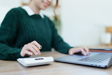 financial, Planning, Marketing and Accounting, portrait of Asian employee checking financial statements using documents and calculators at work