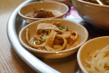 Stir-fried fish cake is served as a side dish.