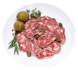 slices of Spanish Fuet thin dried salami sausage on white ceramic plate