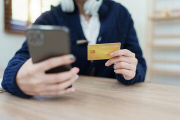 Online Shopping and Internet Payments, Asian man are using their credit card and mobile phone to shop online or conduct errands in the digital world.