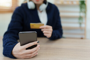 Online Shopping and Internet Payments, Asian man are using their credit card and mobile phone to shop online or conduct errands in the digital world.