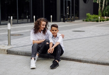Obraz premium cheerful smiling boy walks with his mother