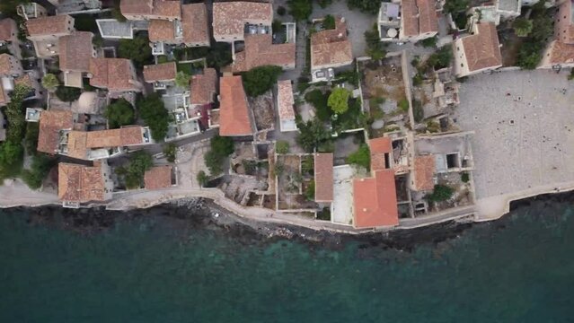 Birds Eye View, Cinematic Monemvasia Architecture and its rooftops. Square in a city by the water. Tourist destination.