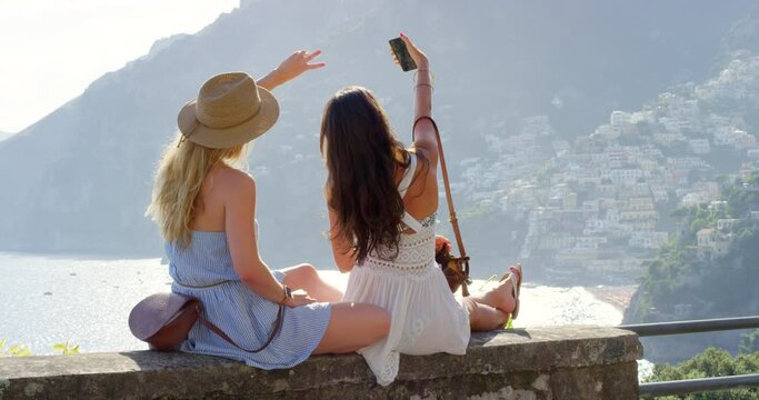 Phone, travel or friends take a selfie in nature by a mountain or city in Italy for social media holiday content. Photography, peace sign or women taking pictures on vacation with freedom in summer