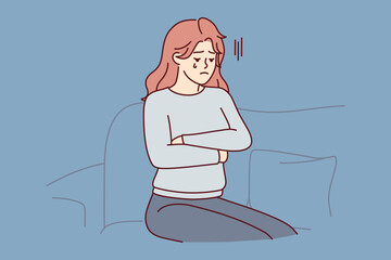 Upset woman crying sitting on couch because of breakup with boyfriend or death of loved one. Unhappy girl in casual clothes with arms crossed is going through after losing job. Flat vector image 