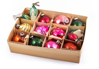 Box of old Christmas toys on a white background. Christmas balls in a box
