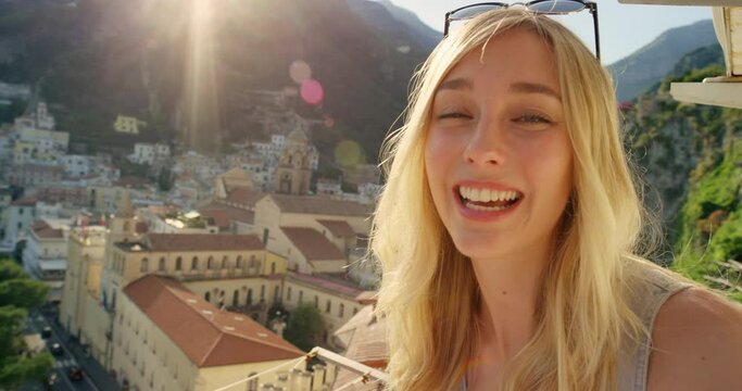 Woman face, holiday and video call of a female adventure vlogger video in Italy on vacation. Apartment balcony, happiness with travel lifestyle selfie in a villa with freedom and smile happy