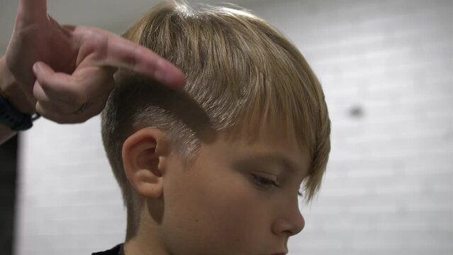 Closeup of hair stylist teaching cutting techniques