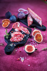 Spanish salami fuet with fresh figs - dry-cured and natural fermented sausages