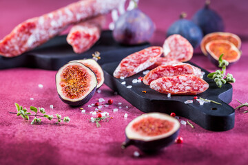 Spanish salami fuet with fresh figs - dry-cured and natural fermented sausages