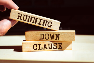 Wooden blocks with words 'Running Down Clause'.