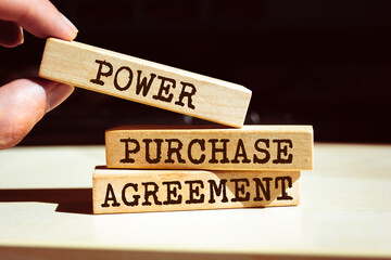 Wooden blocks with words 'Power Purchase Agreement'.