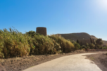 Fototapeta na wymiar Old tower and Path to the Playazo beach in Rodalquilar, Almeria, Spain