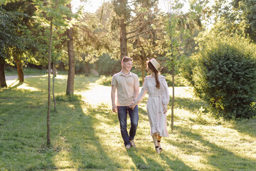 Young couple in love outdoor.Stunning sensual outdoor portrait of young stylish fashion couple posing in summer in field