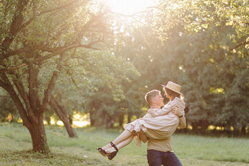 Fototapeta premium Young couple in love outdoor.Stunning sensual outdoor portrait of young stylish fashion couple posing in summer in field