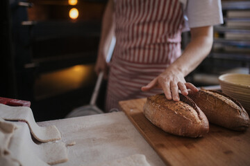 Close-up of baker with fresh bread.