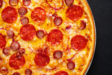 salami pizza on the black background