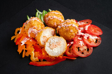 Rice balls stuffed with mozzarella cheese and salmon