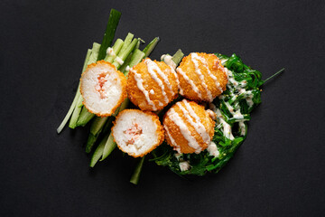 Rice balls stuffed with mozzarella cheese and salmon