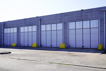 Fototapeta na wymiar Exterior of modern distribution center warehouse grey door facade