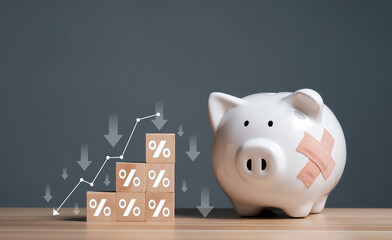 Falling income, lower wages. Decrease in GDP. Economic recession, crisis. Saving inflation, financial crisis and loosing money concept. Piggy bank with decreasing piles of coins on wooden cubes.