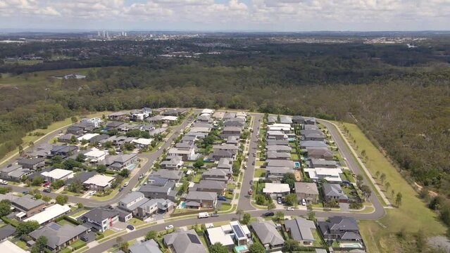 Aerial drone view of Voyager Point in South West Sydney, NSW Australia showing development of housing and parks with Liverpool CBD in the distant background   
